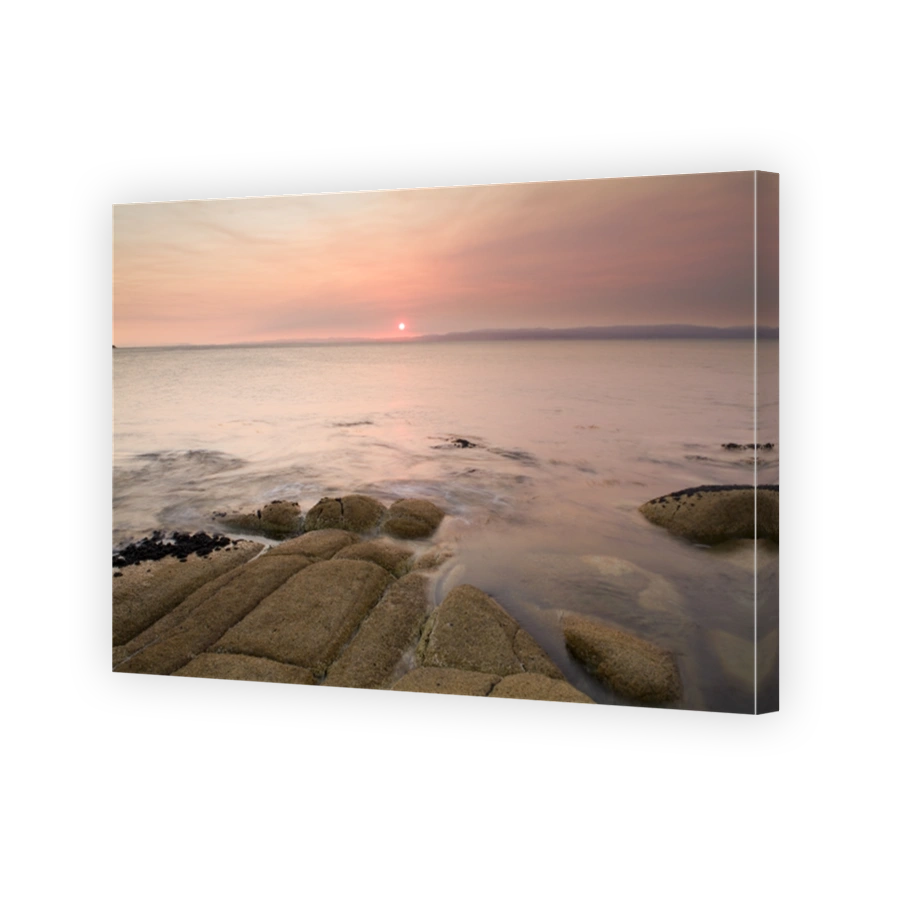 A pink sunset from a coastal scene