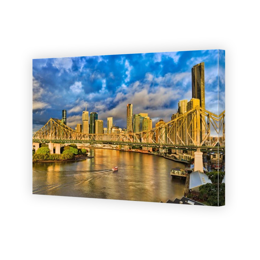 Story bridge across Brisbane river in Brisbane city in front of CBD high-rise business and apartment towers under blue cloudy sky and passenger ferry