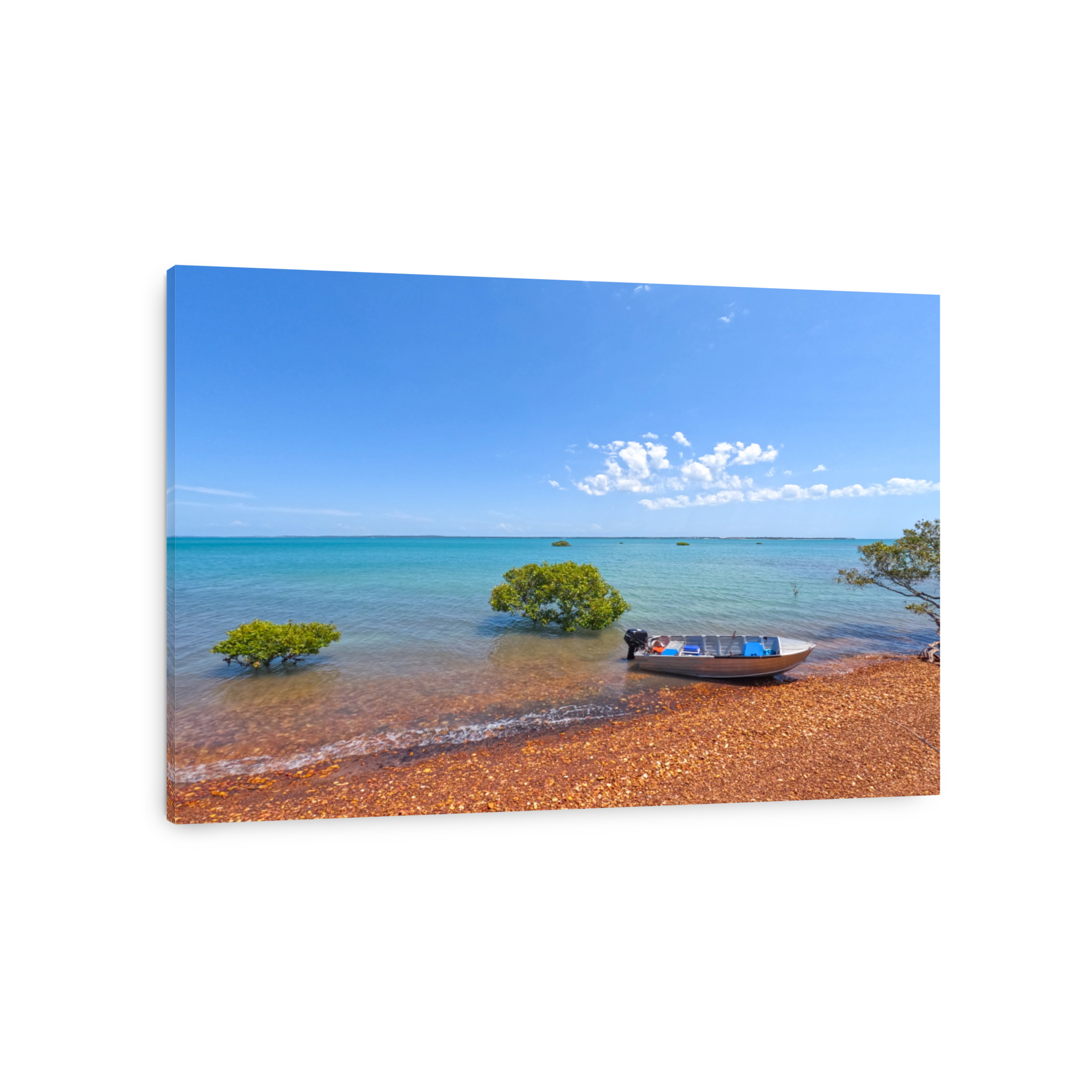 Looking out over brown rocks from the beach into the blue calm water.  Mangrove trees in the water.  Blue skies.  Silver tinnie boat parked up on the shoreline.  Hervey Bay Queensland Australia