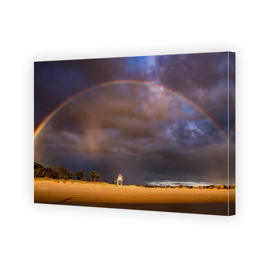The view of a lone beach lifeguard tower under the sunlight and rainbow in Broadbeach in Gold Coast