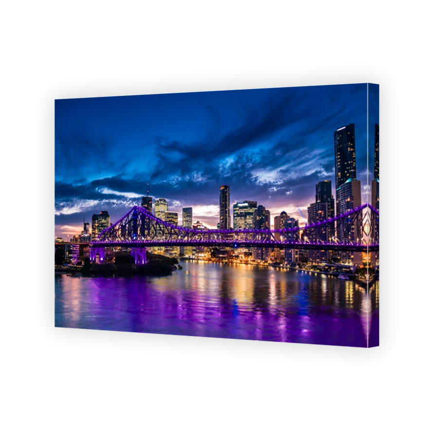 Vibrant night time panorama of Brisbane city with purple lights on Story Bridge