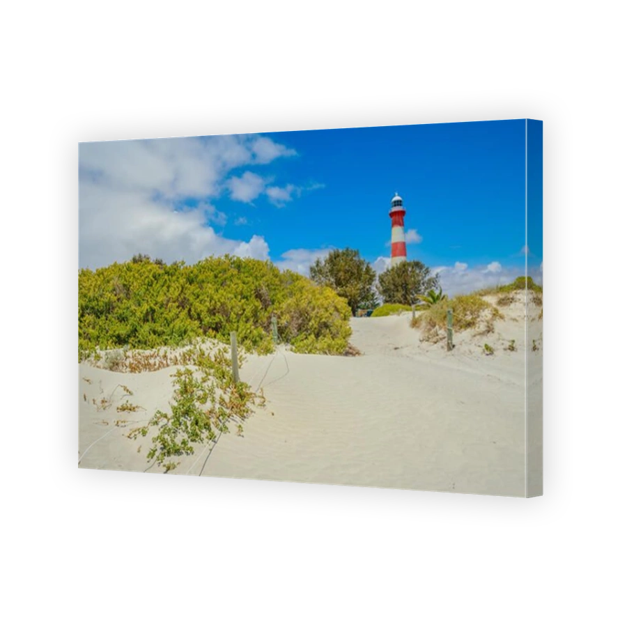 Scenic red and white Moore Lighthouse Point on blue sky in Geraldton, Western Australia, from pristine beach with dunes The historic steel tower is built in 1878. Iconic landscape in Geraldton.