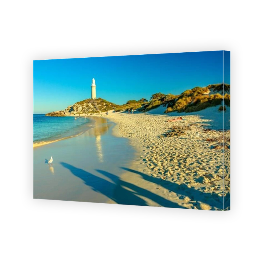 Rottnest Island, Western Australia - Jan 4, 2018: people on Pinky Beach and Bathurst Lighthouse reflecting on turquoise sea in late afternoon. North