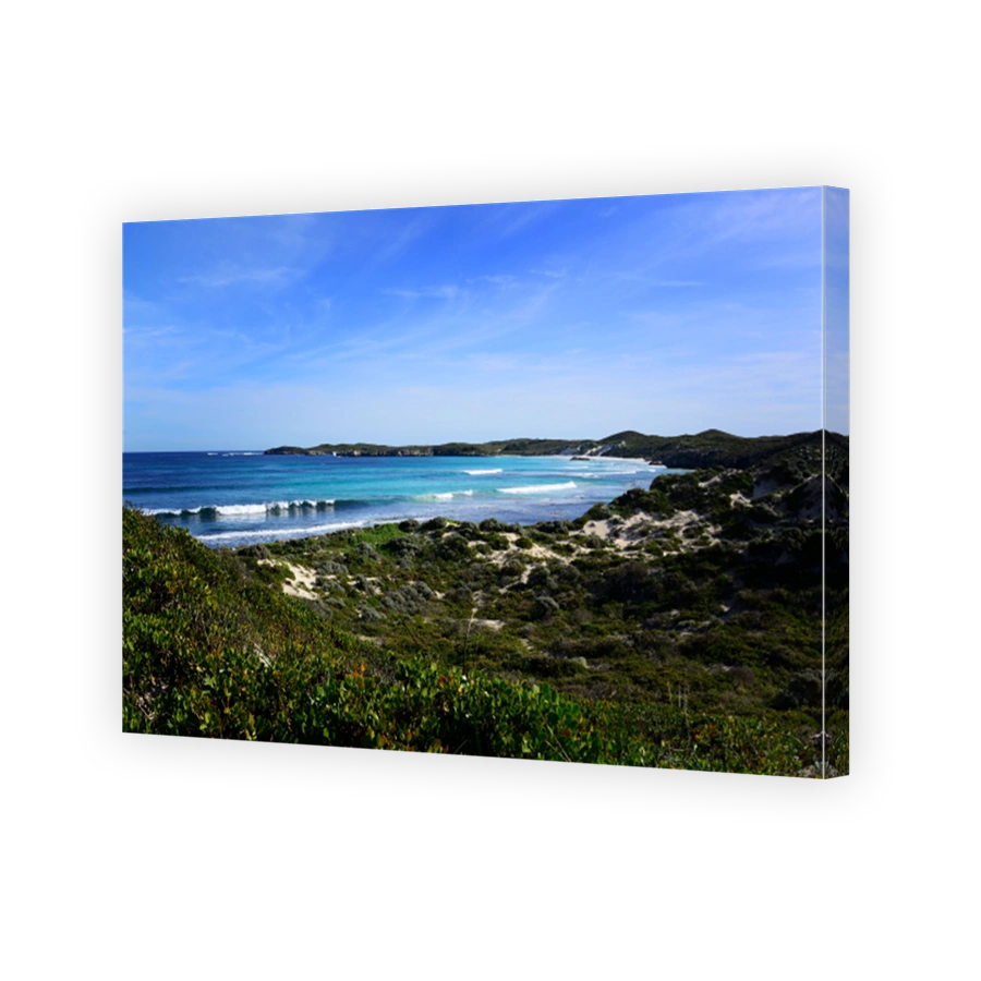 Scenic shot of rocky land and coastline under a beautiful sky