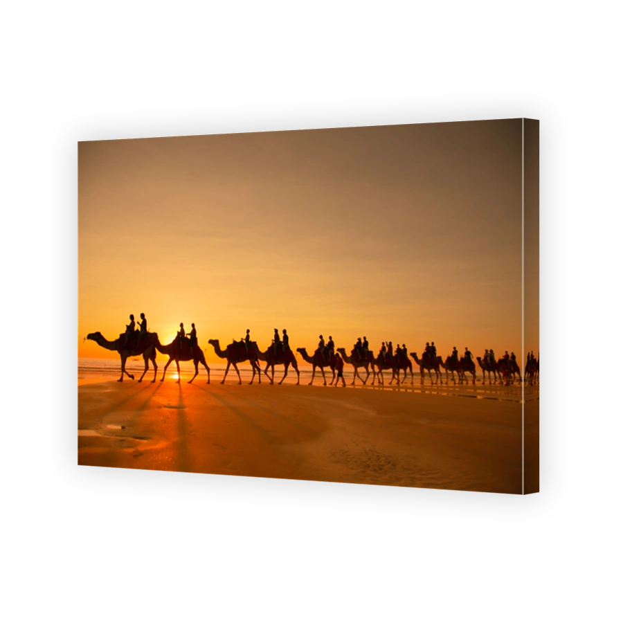 Group Of Silhouette People Riding Camels Along The Beach In Broome, Australia