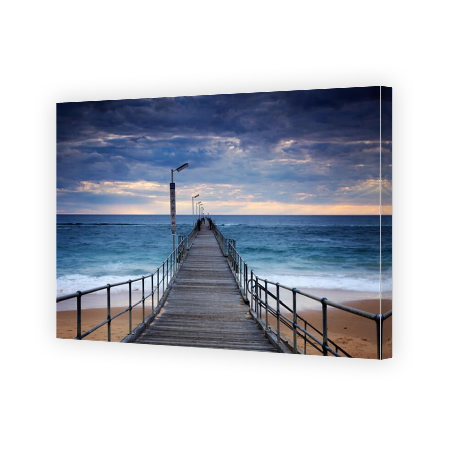 Port Noarlunga Jetty with storm clouds overhead with people fishing