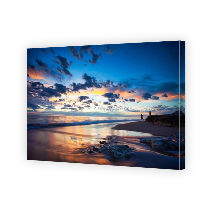 A couple watching the sunset at Port Noarlunga Beach South Australia