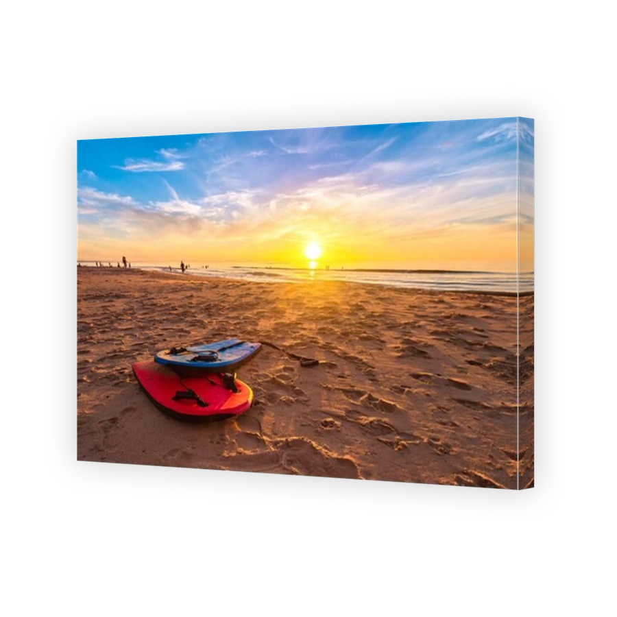 Swimming bodyboards on the beach at beautiful sunset on a warm summer evening, South Australia
