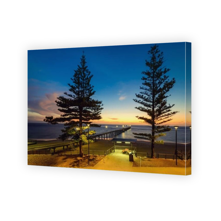 Port Noarlunga jetty with foreshore picnic table at dusk, South Australia