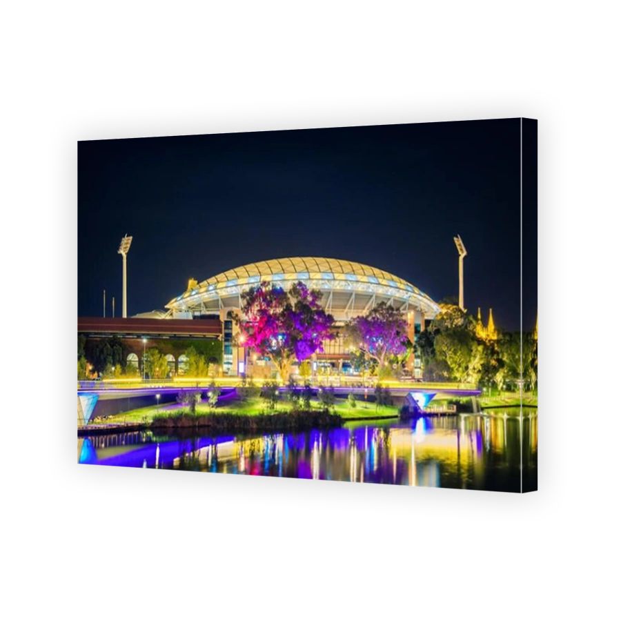 Adelaide, Australia - April 16, 2017: Adelaide Oval with footbridge across Torrens river illuminated at night time