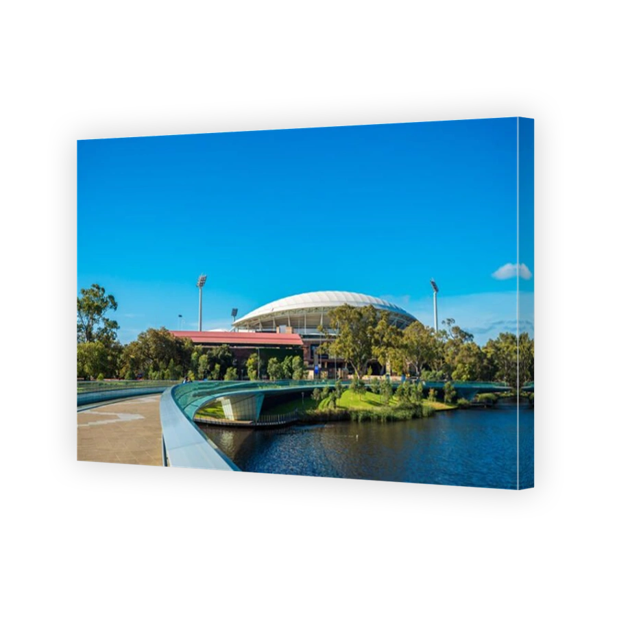 Adelaide, Australia - January 13, 2017: Iconic Adelaide Oval viewed across Torrens river foot bridge in Elder Park on a bright day