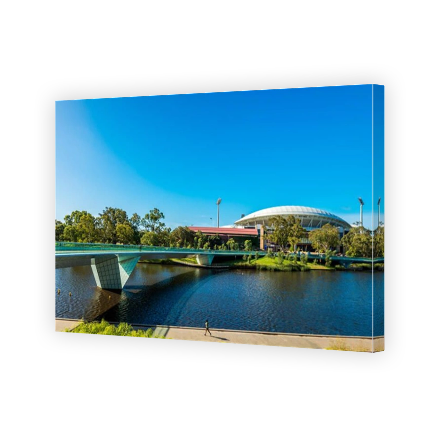 Adelaide, Australia - January 13, 2017: Iconic Adelaide Oval viewed across Torrens river foot bridge in Elder Park on a bright day