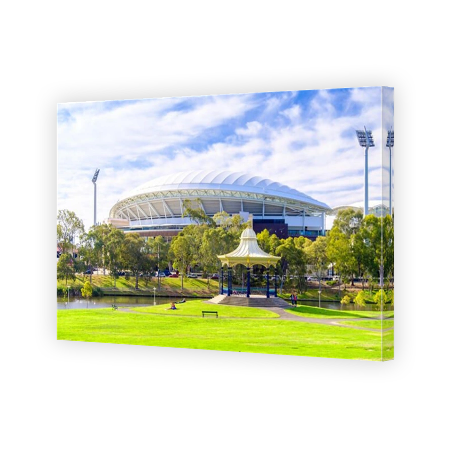 Adelaide, Australia - December 2, 2017: People relaxing near Elder Park Rotunda with Adelaide Oval on the background on a warm summer day