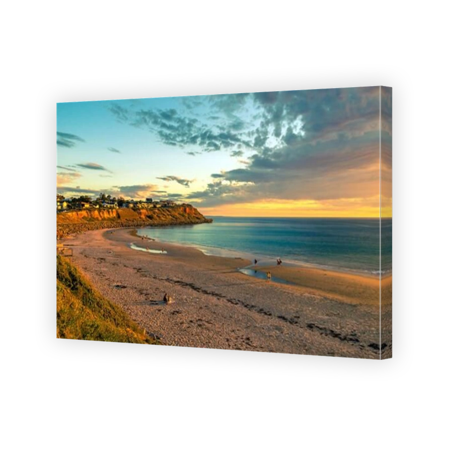 Adelaide, South Australia - October 7, 2018: People walking along the shore while enjoying beautiful sunset at Christie's Beach on a warm evening