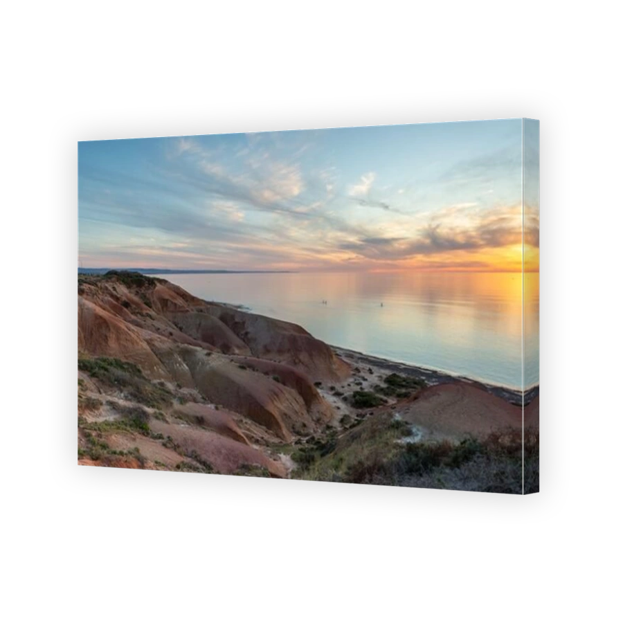 The beautiful Seaford beach at sunset with standup paddle boarders in the distance in South Australia on November 2 2020