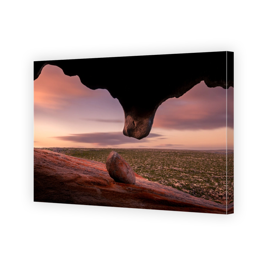 Dramatic scene of a pink sunset view from inside a cave opening, Kangaroo island, South Australia