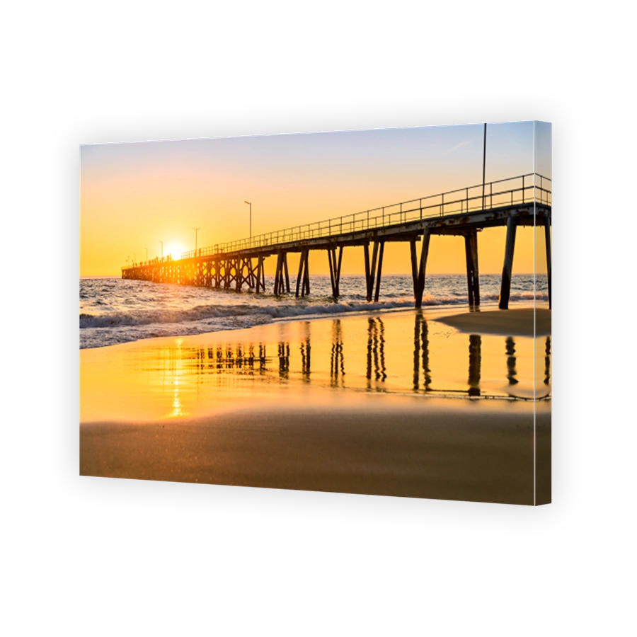 People walking on Port Noarlunga jetty at sunset