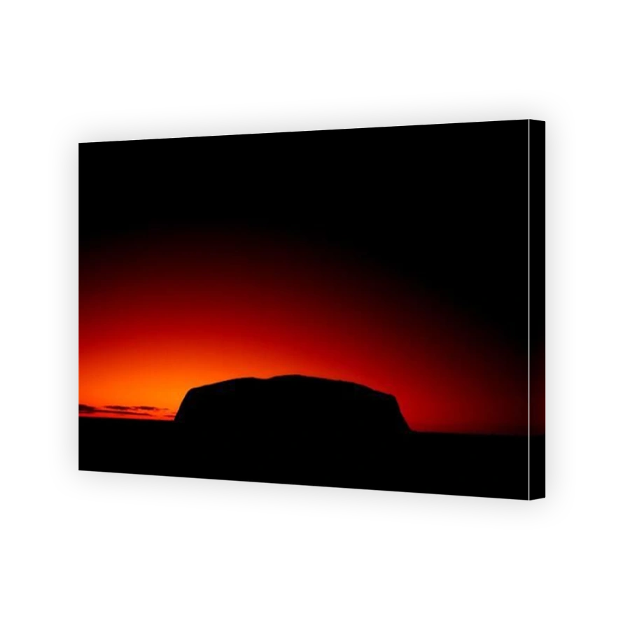 Silhouette outline of Ayers Rock or Uluru in red sunrise or sunset, dusk or dawn, red sky, Northern Territory, Australia