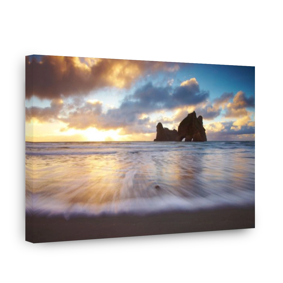Wharariki Beach. The incoming tides rushes in on Wharariki beach as the sun sets. Looking towards a fascinating large arched roc