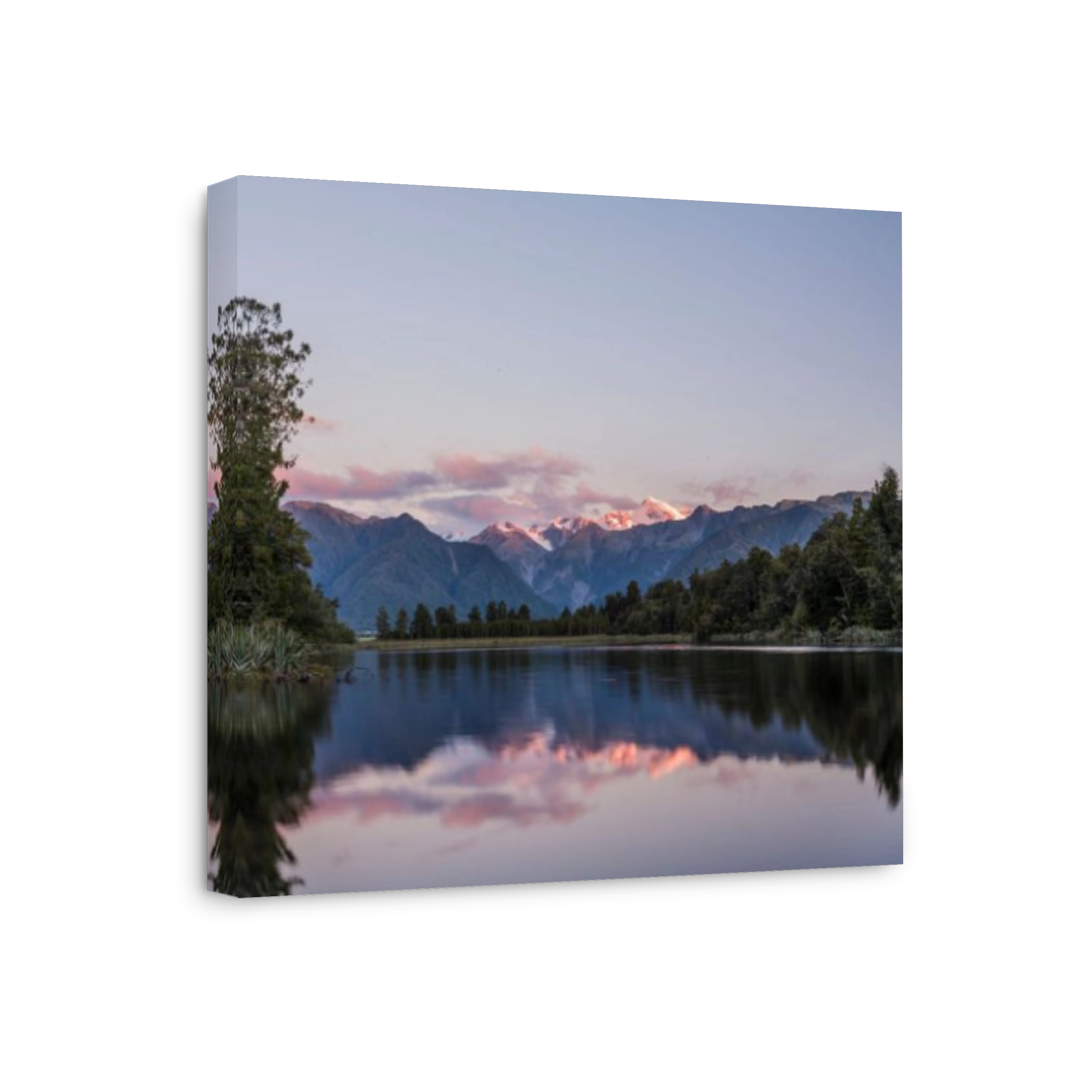 Lake Matheson at sunset with snow covered Mount Cook, New Zealand's highest mountain.