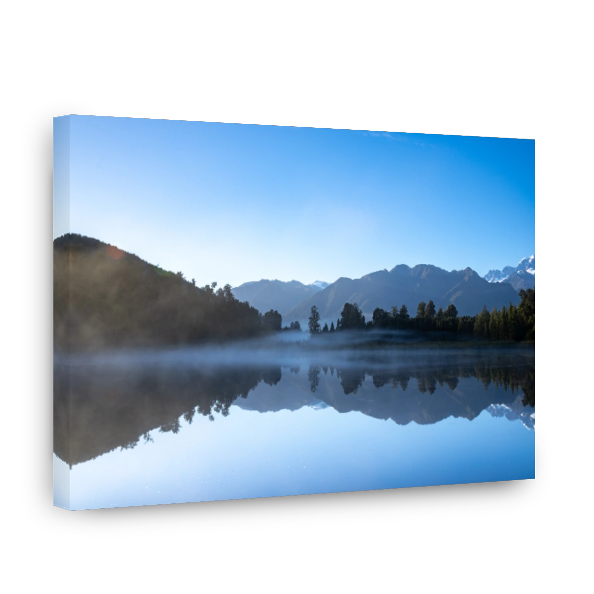 Perfect reflection in Lake Matheson surrounded by beautiful natural forest under blue sky