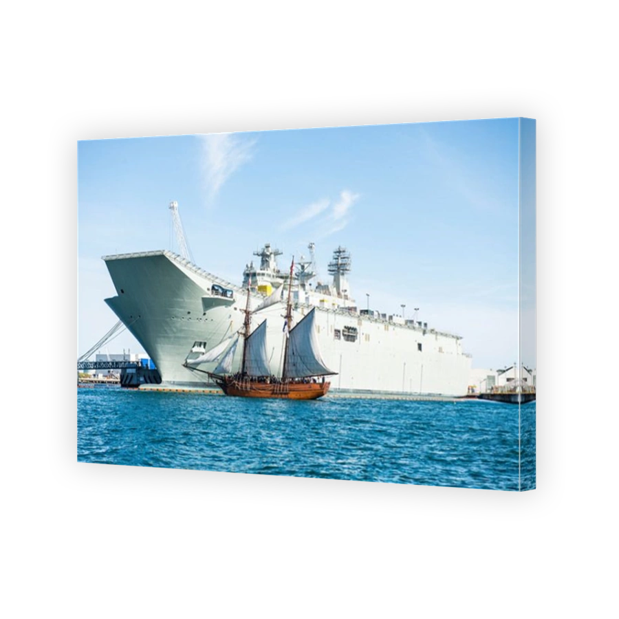Enterprize replica sails past new aircraft carrier at Williamstown, Victoria