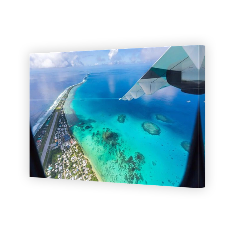 Tuvalu, Polynesia under the wing of an airplane. Aerial view of Funafuti atoll and the airstrip of International airport in Vaiaku. Island nation.