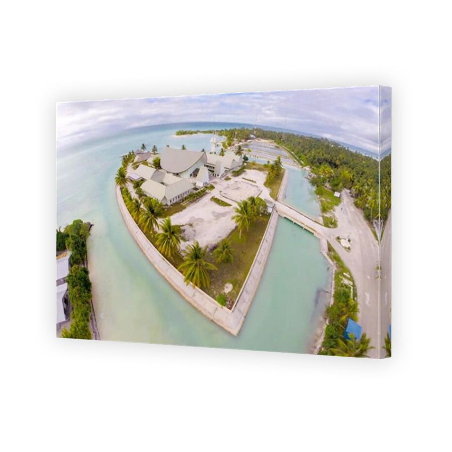 Maneaba ni Maungatabu (Parliament of Kiribati) building on motu in an atoll's lagoon, aerial view. House of Assembly, Ambo, South Tarawa, Kiribati, Gi