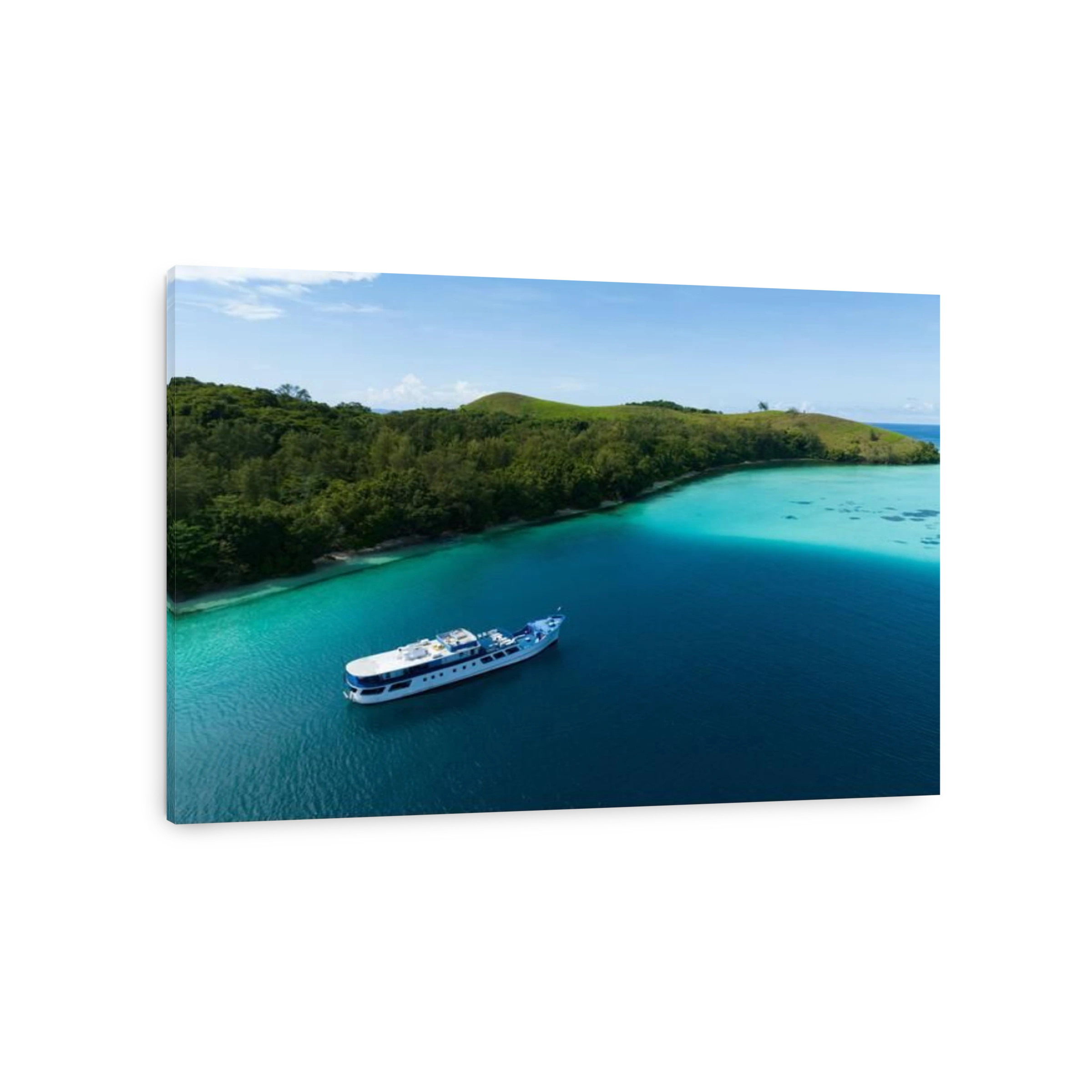 A dive boat sits at anchor next to a remote, idyllic island in the Solomon Islands. This beautiful area is home to extraordinary coral reefs.