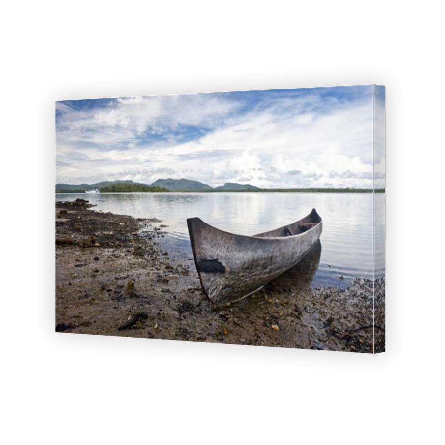 A dugout canoe is pulled up to shore near a remote village that lies in the Russell Islands, part of the Solomon Islands.