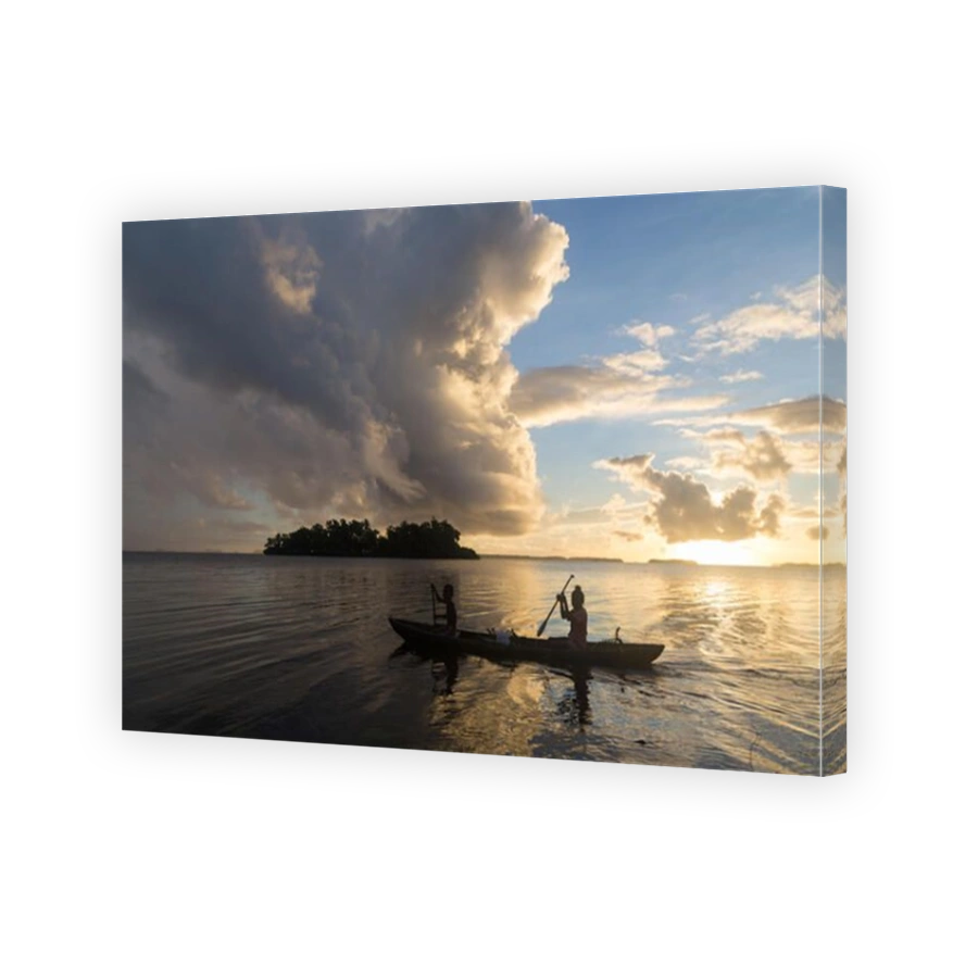 Children on the way to school with a canoe during sunrise in the Solomon Islands.
