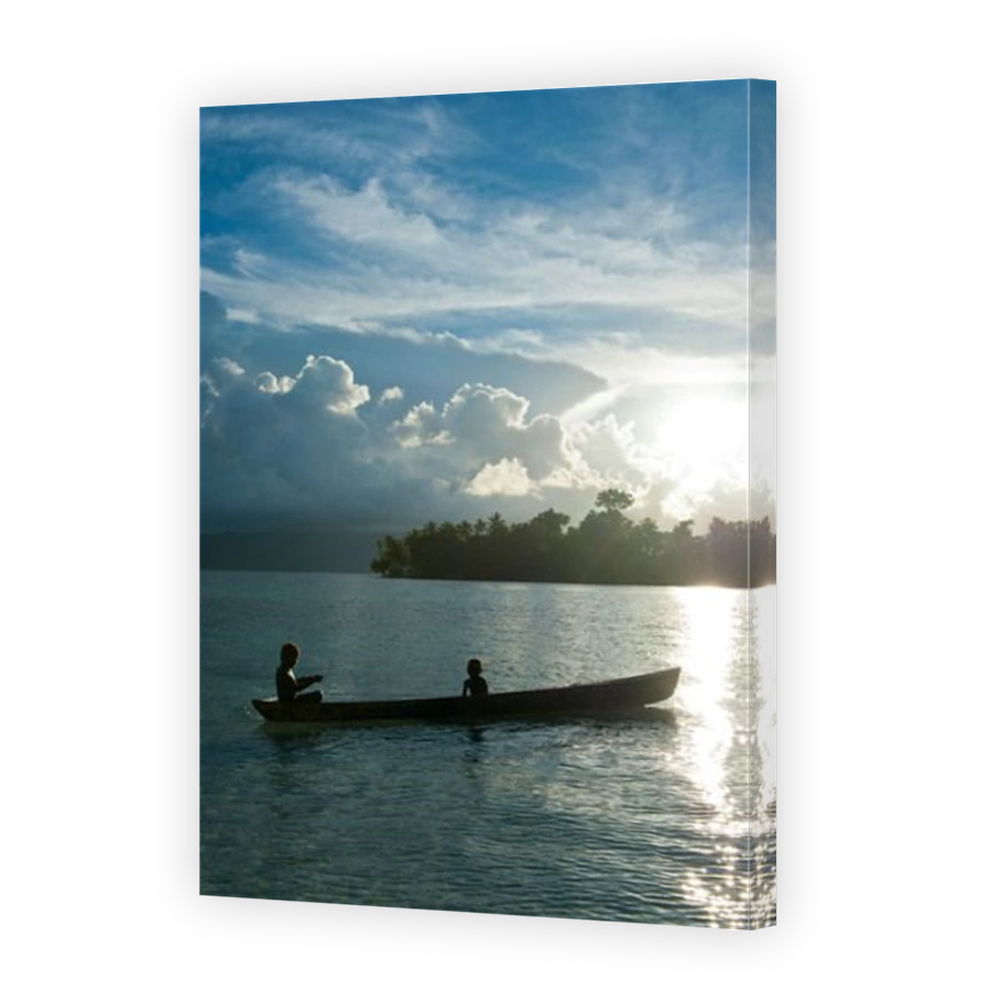 Boys in a canoe in backlit in the Marovo Lagoon, Solomon Islands, Pacific