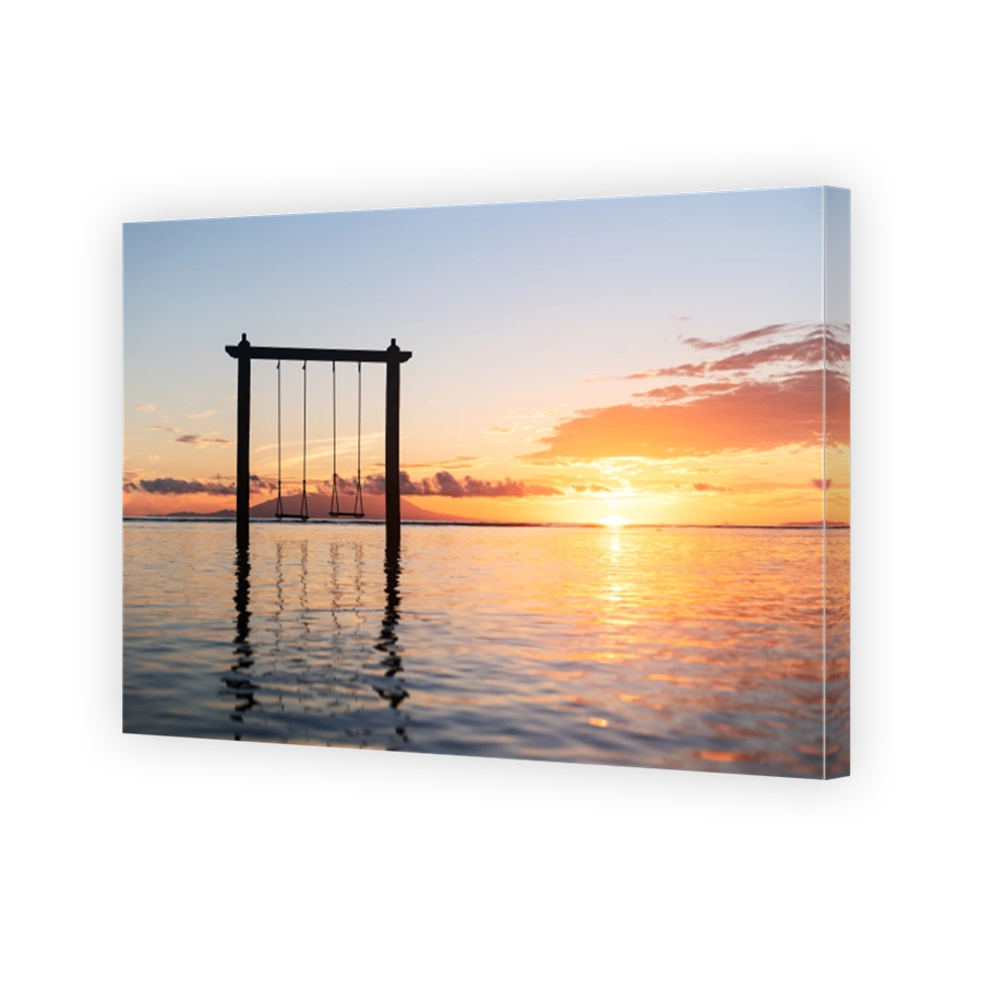Swing on seashore during the sunrise. Sky and reflections on the water in the summer. Sun rays during the sunrise. Nusa Penida, Bali, Indonesia. Travel - image