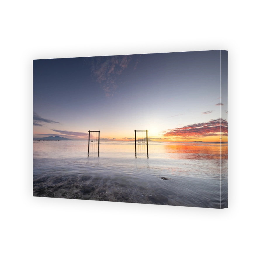 Swings on seashore beach during the sunrise. Sky and reflections on the water in the summer. Sun rays during the sunrise. Nusa Penida, Bali, Indonesia. Travel - image