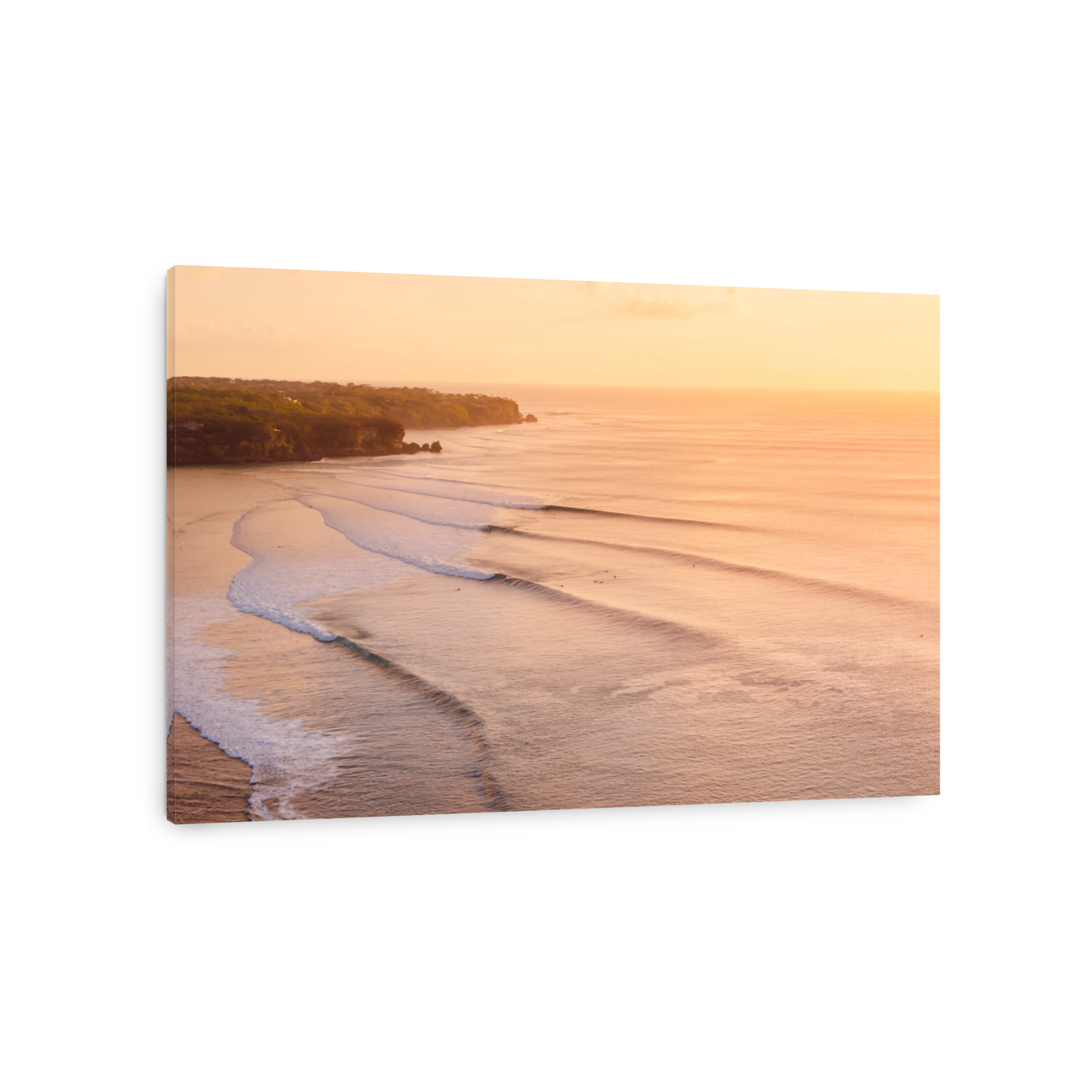 Scenic drone landscape with warm sunset tones and ocean with surfing wave in Bali.