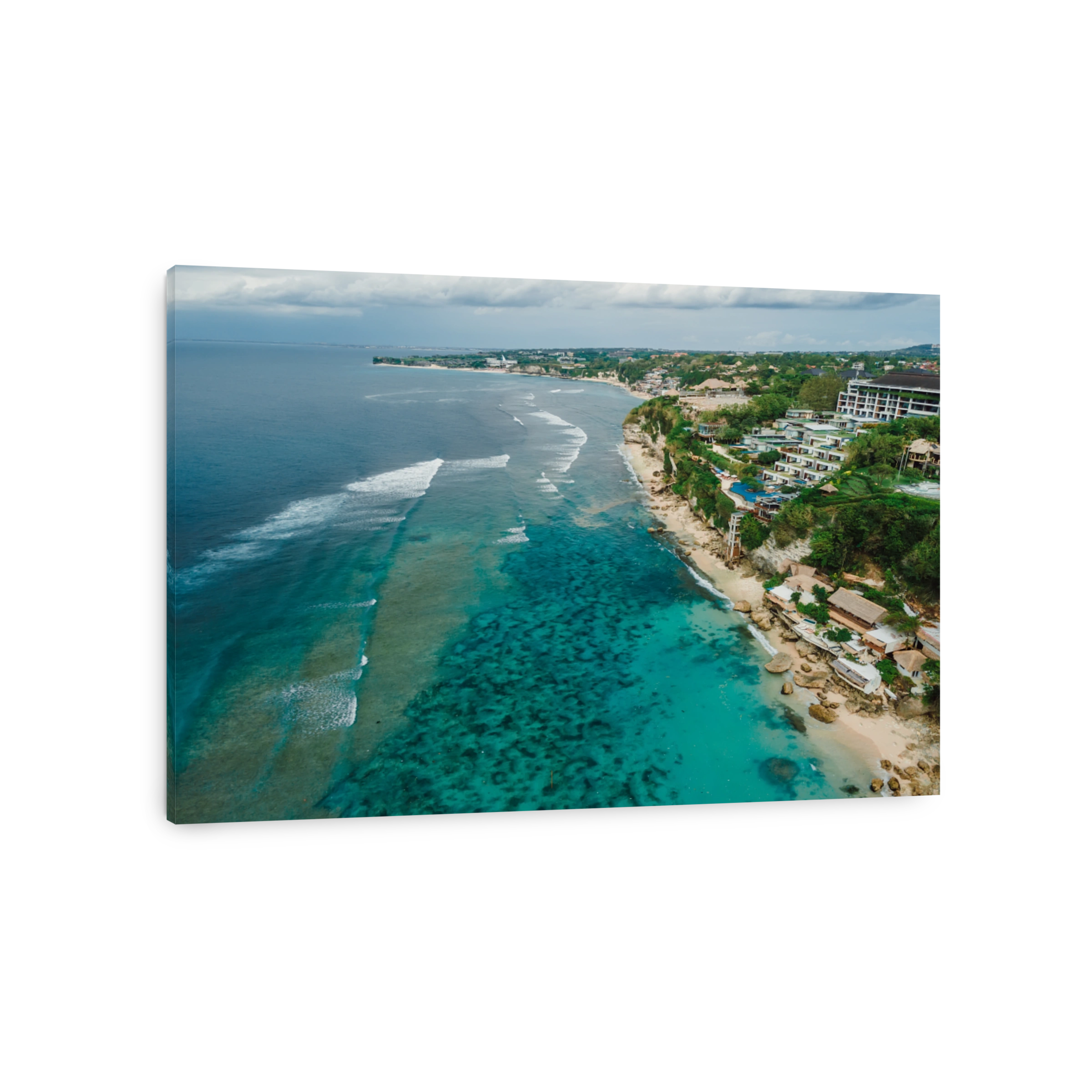 Ocean and coastline with hotels on Impossibles beach in Bali. Aerial view of tropical island