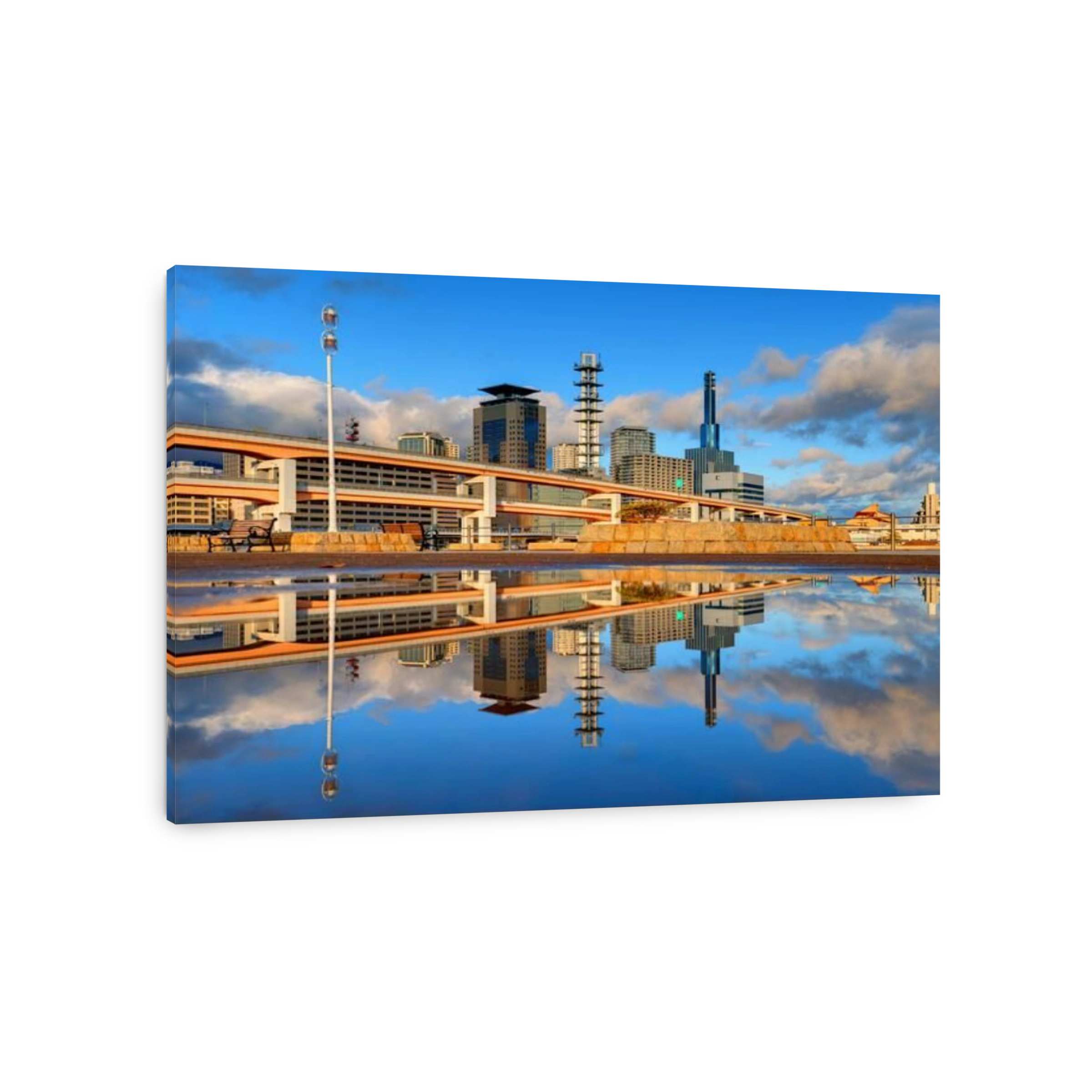 Modern cityscape with natural reflections in a puddle of Kobe, Japan.