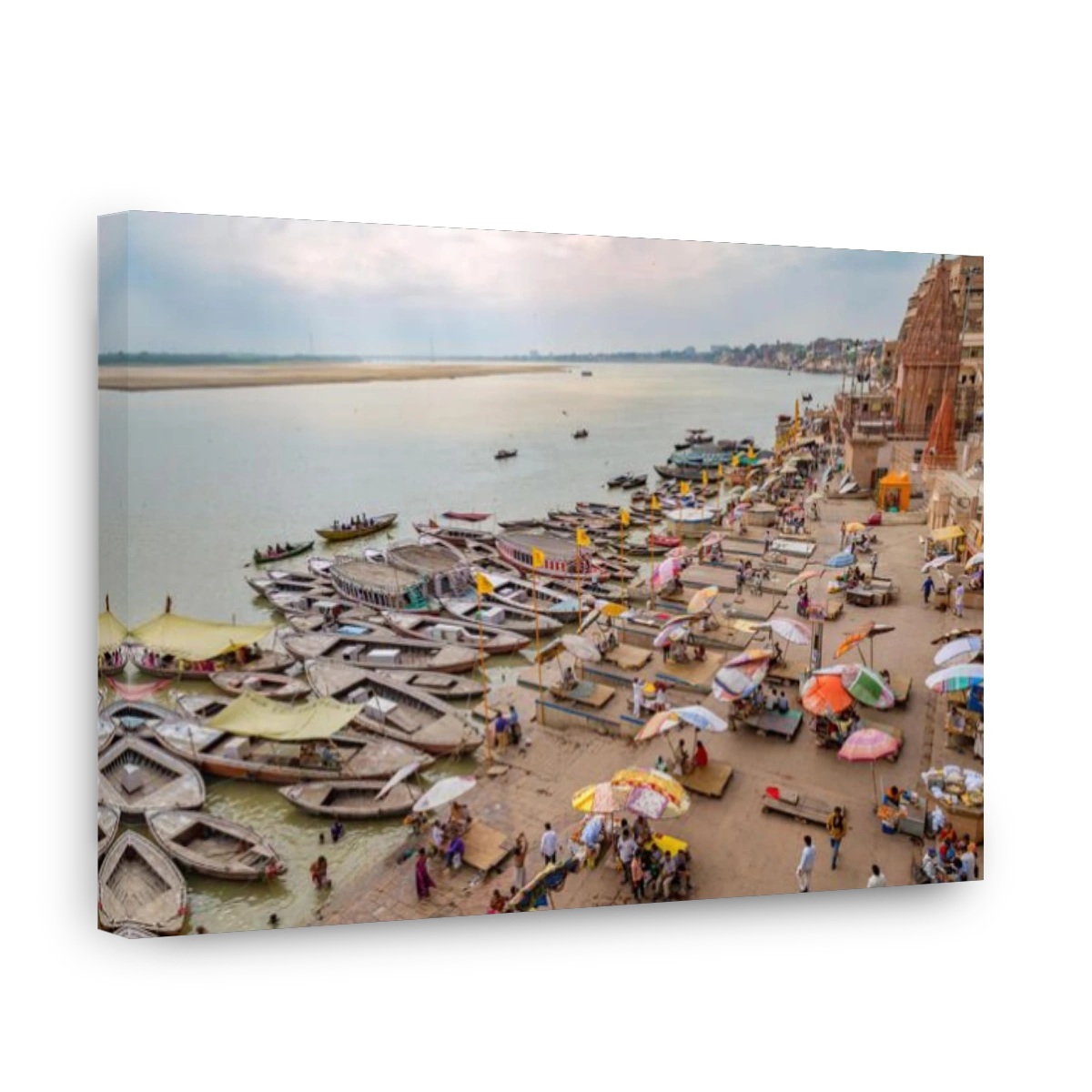 Varanasi India Ganges river bank aerial view with ancient architectural buildings and wooden boats along the Ganga river ghat.