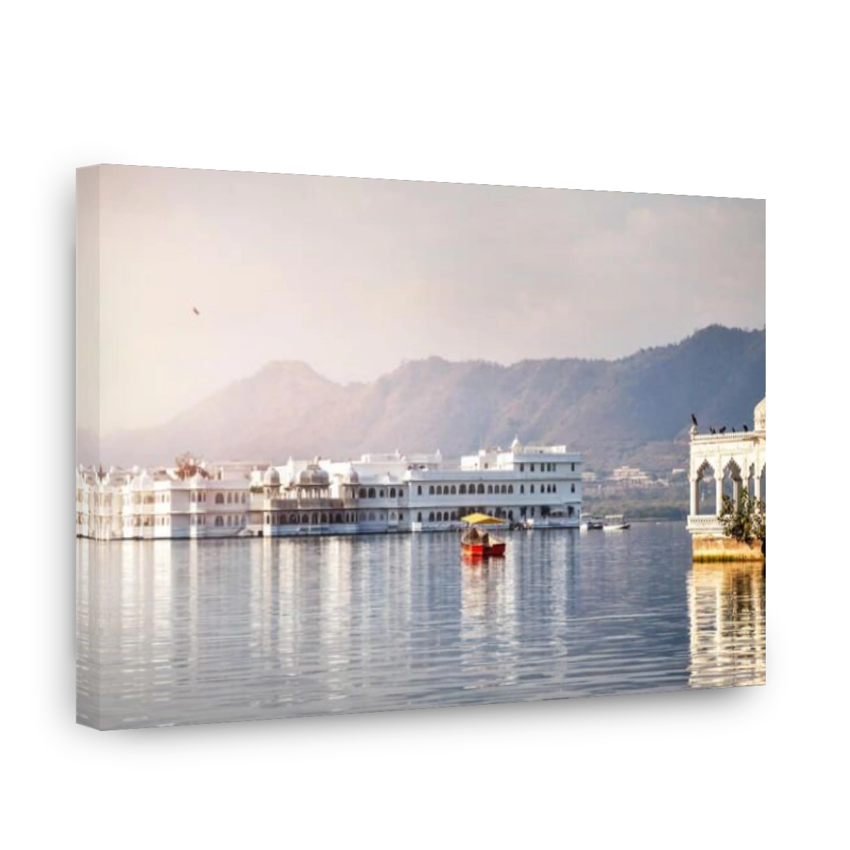 White palace and boat on Lake Pichola in Udaipur, Rajasthan, India