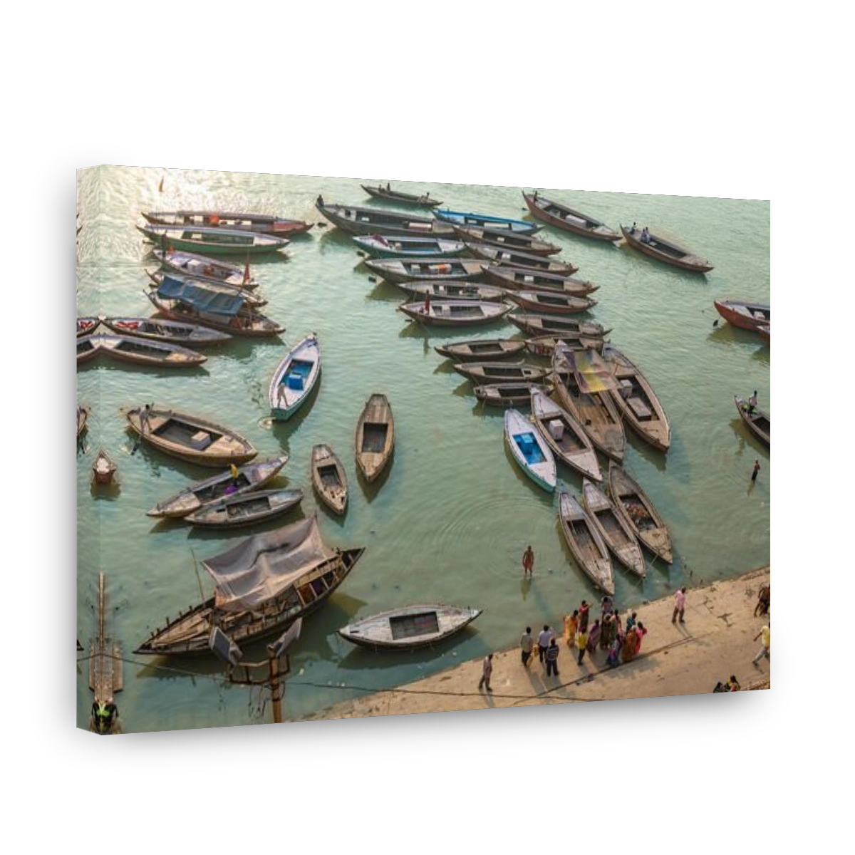 Varanasi India Ganges river bank aerial view with ancient architectural buildings and wooden boats along the Ganga river ghat.