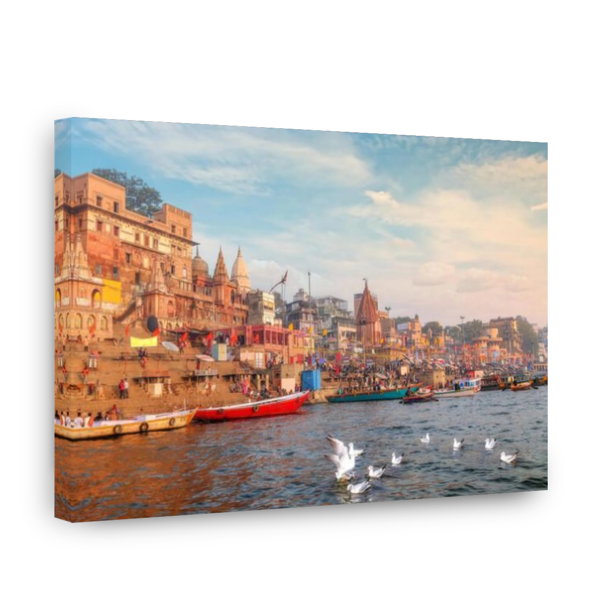 Varanasi ancient India city architecture as viewed from a boat on river Ganges with  view of migratory birds with moody sunset sky