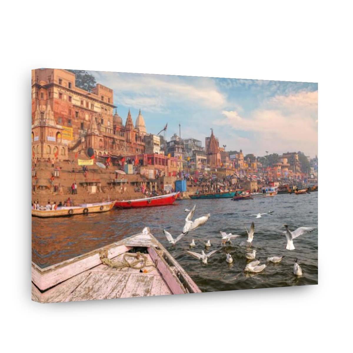 Varanasi ancient India city architecture as viewed from a boat on river Ganges with  view of migratory birds with moody sunset sky