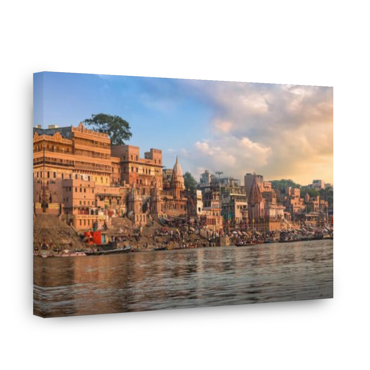 Historic Varanasi city and Ganges river ghat at sunset with ancient temples and buildings.