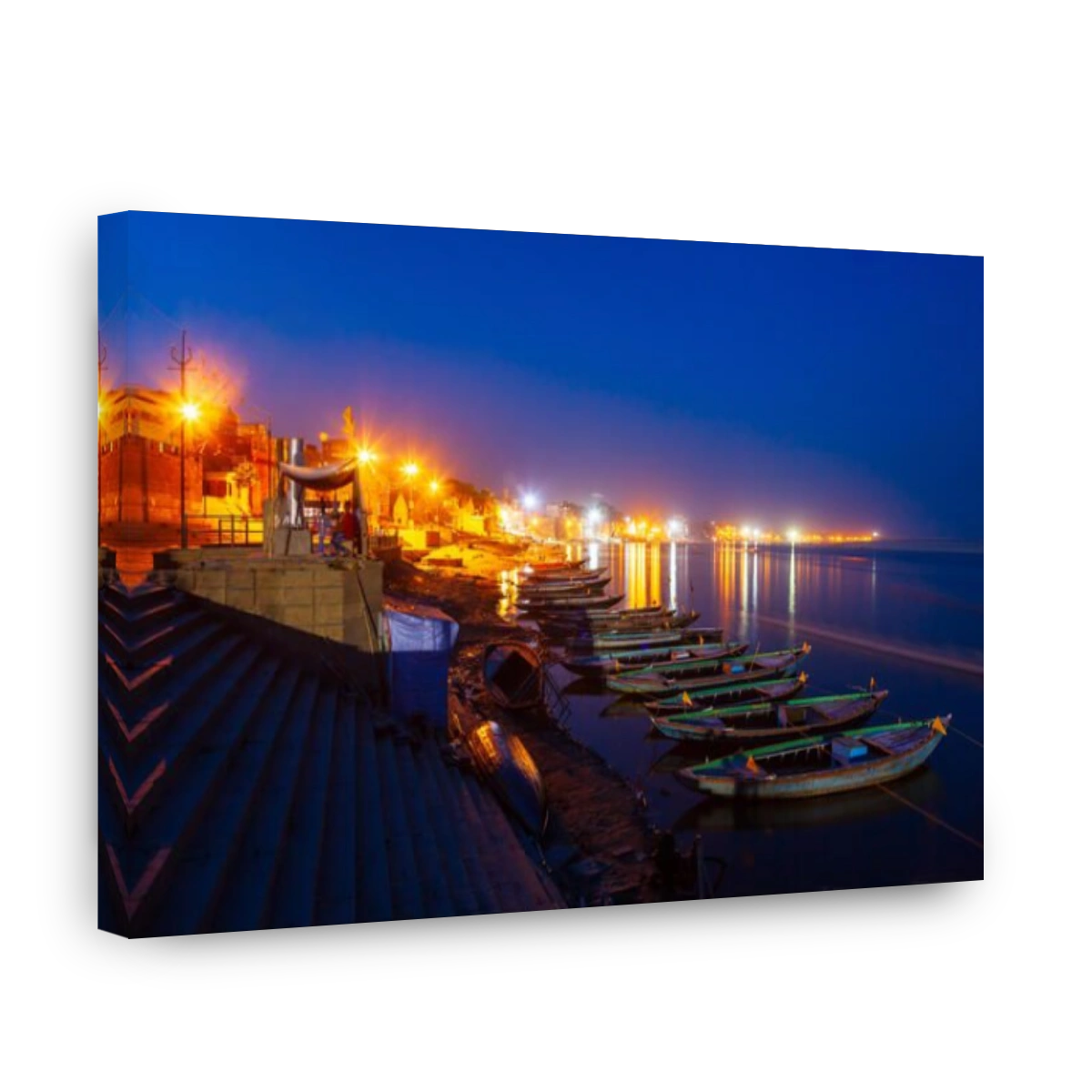 Colorful boats and Ganges river bank in Varanasi city in India at night