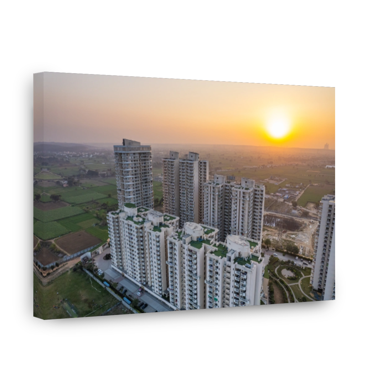 aerial drone shot of luxury rich opulent high rise buildings for residence office shopping surrounded by green fields with mountains off in the distance showing living in the middle of nature