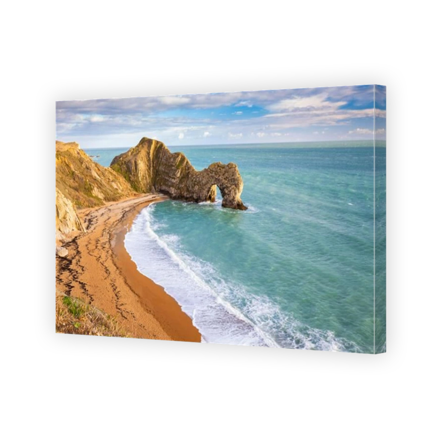 Aerial view at sunset of the Durdle Door, a natural limestone arch on the Jurassic Coast near Lulworth in Dorset, Southern England.