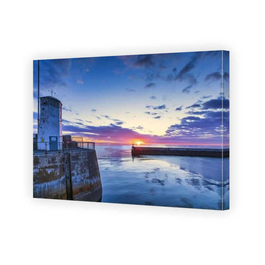 A colourful sunrise at Seahouses harbour on the Northumberland coast in England, Uk.