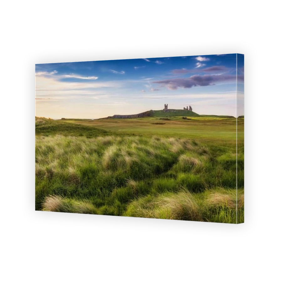 An early morning view of Dunstanburgh Castle in Northumberland, England, Uk