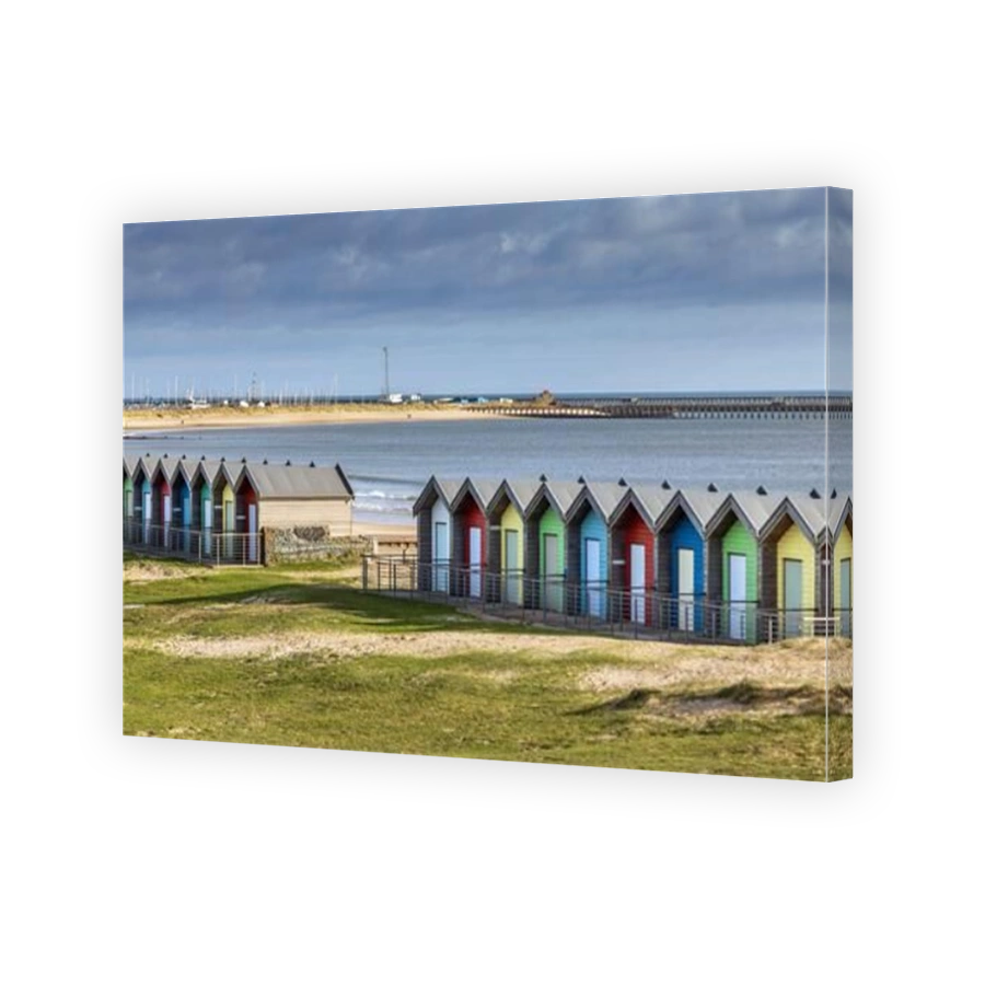 The colourful beach huts on the promenade at Blyth, Northumberland, Uk