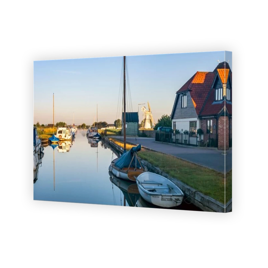 Boats moored at Thurne Mill in the Norfolk Broads, Norfolk, England